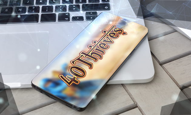 Ein Notebook auf dem ein Smartphone liegt auf dem das Logo des 40 Thieves Slot zu sehen ist.
